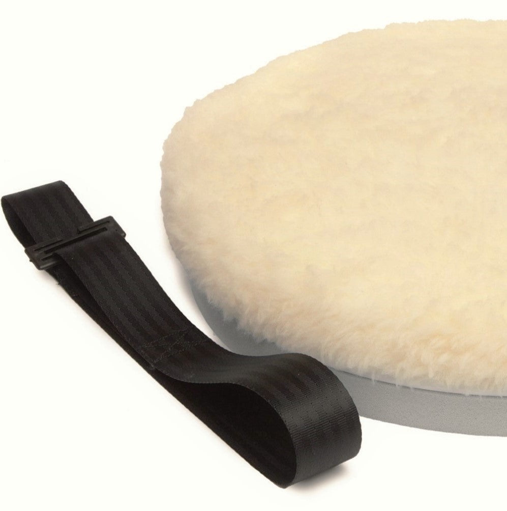Round white turning cushion with black belt on a white background