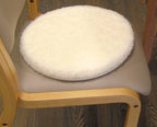 Round white turneasy turning disk cushion on a chair with wooden frame