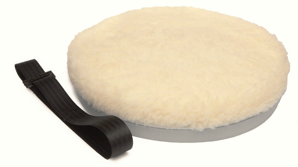 Round white turning cushion with a black belt on a white background