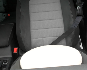 Car seat with a white turning cushion on a black background